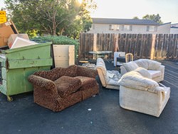 PHOTO BY KASEY BUBNASH - IS THIS THE DUMP? Couches, chairs, tables, and a mini-fridge sit outside an apartment complex near Cal Poly just before San Luis Garbage's fall Cleanup Week.